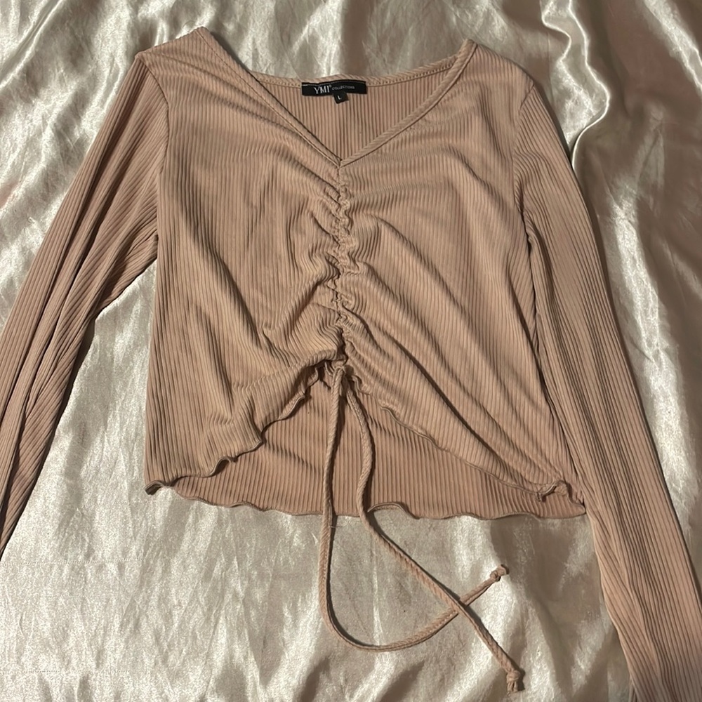 a beige long sleeve kind of shirt , i bought it to big so never warn.